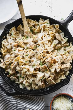 a skillet filled with pasta and chicken