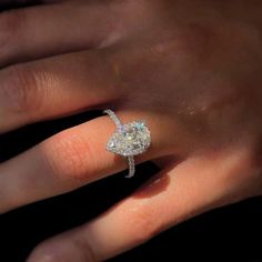 a woman's hand with a diamond ring on it