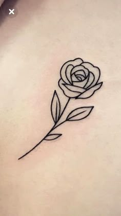 a rose tattoo on the back of a woman's stomach