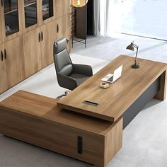 an office desk with a laptop on it in front of a bookcase and cabinets