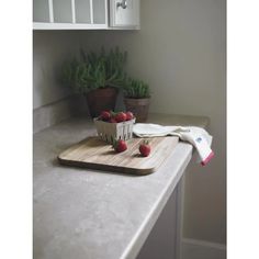 some strawberries are sitting on a cutting board