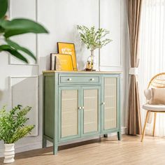 a green cabinet with wicker doors in a living room next to a chair and potted plant