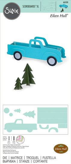 a paper cutout of a blue truck with trees on the side and an arrow in the back