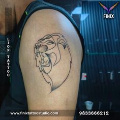 a man with a tattoo on his arm and the face of a lion is shown