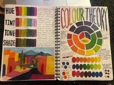 an open notebook with color swatches and markers