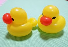 two yellow rubber ducks sitting on top of a table