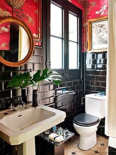 a black and white bathroom with red walls