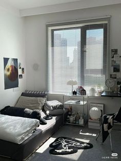 a bedroom with a bed, desk and window