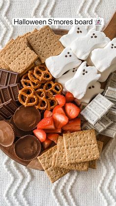 halloween s'mores board with marshmallows, pretzels and strawberries