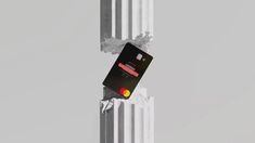 a credit card sticking out of the side of a radiator in front of a gray background