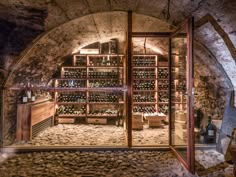 an old wine cellar with many bottles in it