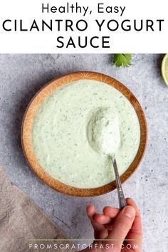 Close up of a hand holding a spoon in a bowl of creamy cilantro yogurt sauce. Sauce For Fish Tacos, Herb Ranch Dressing, Slow Cooker Salmon, Sauce For Fish, Healthy Biscuits, Healthy Tacos Salad, Cilantro Lime Sauce, Taco Sauce