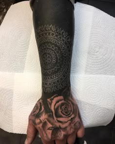 a person with a rose tattoo on their arm