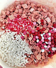 a bowl filled with red, white and pink dog treats