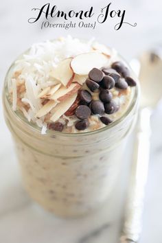 a glass jar filled with oatmeal, chocolate chips and coconut flakes