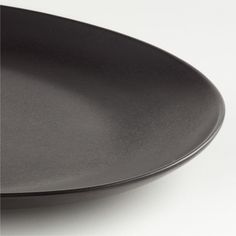 a black plate sitting on top of a white table