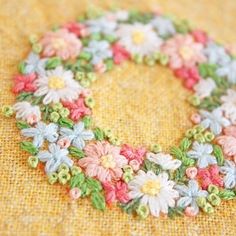 a close up of a piece of fabric with flowers on it and the letter o in the middle