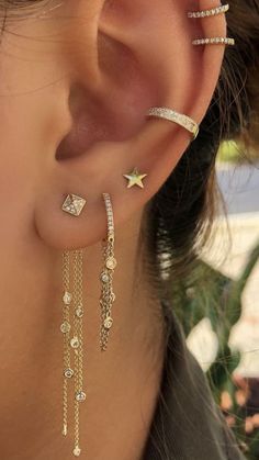 a close up of a person's ear with three different types of piercings