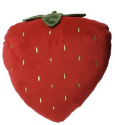 a red strawberry pillow with green leaves on it