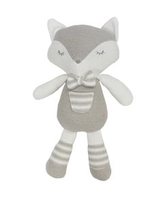 a stuffed animal with a bow on it's head and eyes, sitting in front of a white background