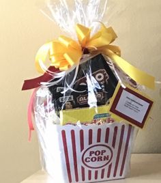 a popcorn bucket filled with chocolates and candy