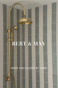 a shower head with the words bert & may made and glazed by hand