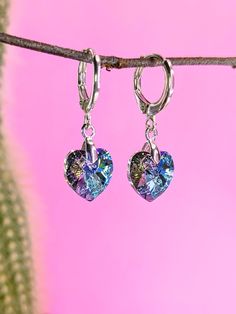 Stunning sparkly dangle earrings with genuine Swarovski crystal hearts in 'Vitrail Light' which is a beautiful lilac and blue colour. Solid sterling silver huggy hoops stamped with 925 for quality. Lever back hoops ensure comfort and security.  This item is handmade by me in Buckinghamshire. I have created a gently angled design so the hearts face forward while wearing. Perfect gift for the bride to be when she needs something blue. Thoughtful present for the fabulous person in your life (it could be you!) Perfect for everyday wear to add some sparkle in your life, or to add a bit more glamour to a special occasion.  Posted in a beautiful gift box. Gift For The Bride, Swarovski Crystal Hearts, Heart Face, Face Forward, Blue Colour, Crystal Heart, Something Blue, Jewelry Earrings Hoops, Beautiful Gift Boxes