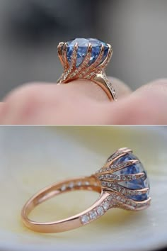 an image of a blue ring with diamonds on top and in the middle, it is being held up by someone's hand