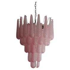 a pink chandelier hanging from a chain