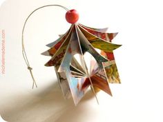 an origami christmas tree decoration hanging from a string