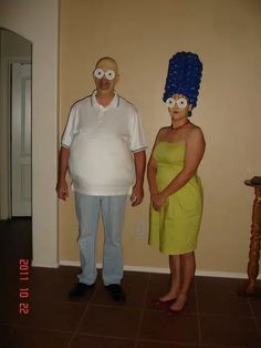 the man and woman are dressed up in costumes