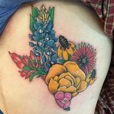 a woman's thigh with flowers and bees on it