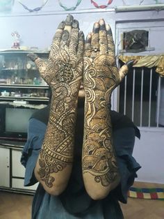 a woman with her hands covered in henna