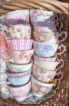 a basket filled with lots of cups and saucers