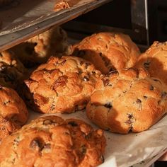 freshly baked cookies and muffins are on display in a bakery oven, ready to be eaten