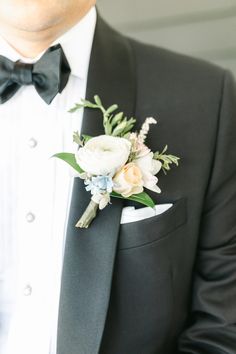 a man in a tuxedo wearing a boutonniere