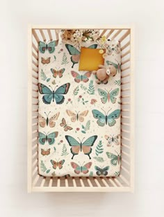 a baby's crib with butterflies on it