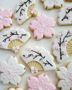 decorated cookies with pink and white icing on a table