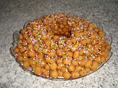 a cake covered in lots of sprinkles on top of a glass plate