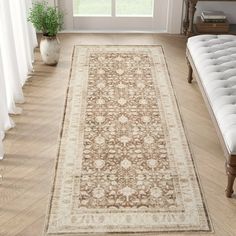 a large area rug is in the middle of a room with white curtains and windows