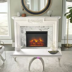 a living room with a fireplace and mirror