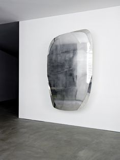 a large mirror mounted to the side of a wall