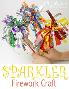 a hand holding up a paper firework craft with the words sparkler on it