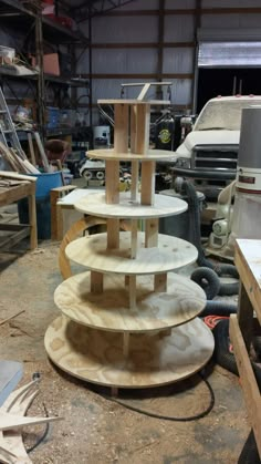 three wooden shelves stacked on top of each other in a garage with tools and equipment