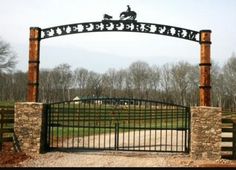 a gated entrance to a horse ranch