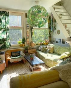 a living room filled with lots of furniture and plants on the windows sills