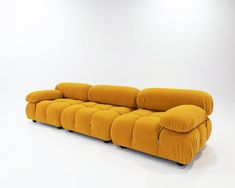 a yellow couch sitting on top of a white floor