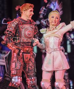 two people dressed in costumes standing next to each other