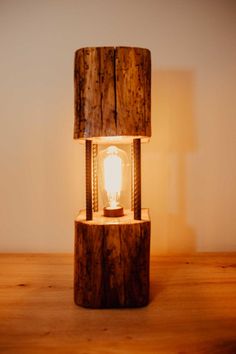 a wooden table lamp with a light bulb on it