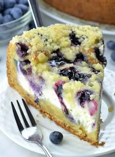 a slice of blueberry cheesecake on a plate with a fork